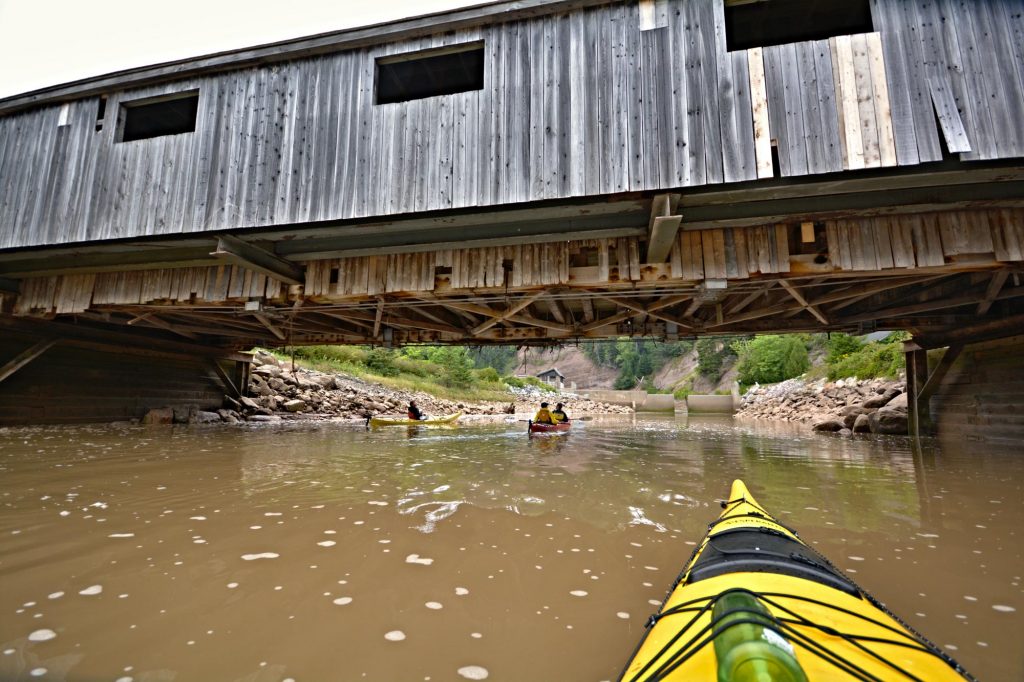 Kayaking with Red Rock Adventure beneath old covered bridges in St. Martins, New Brunswick in the Bay of Fundy