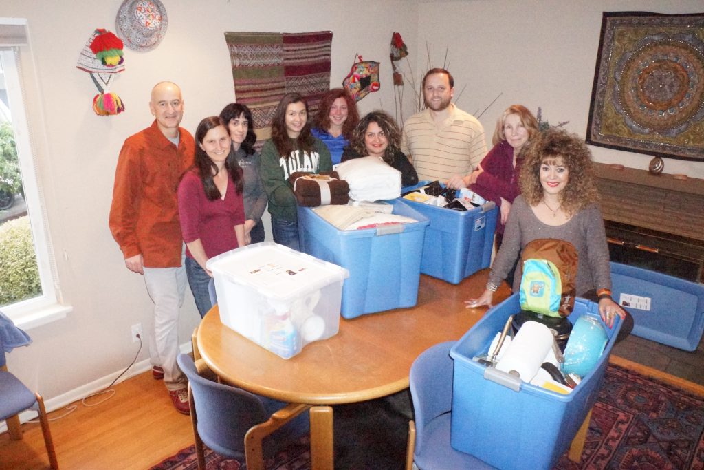 Wildland Adventures staff lends a hand to refugee families who have just arrived in the Seattle area. - © Wildland Adventures
